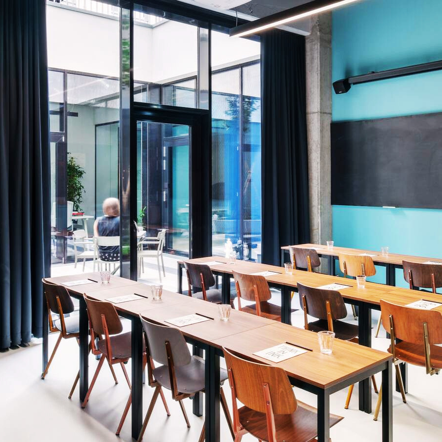 A picture of two smiling women in the audience raising their hands.