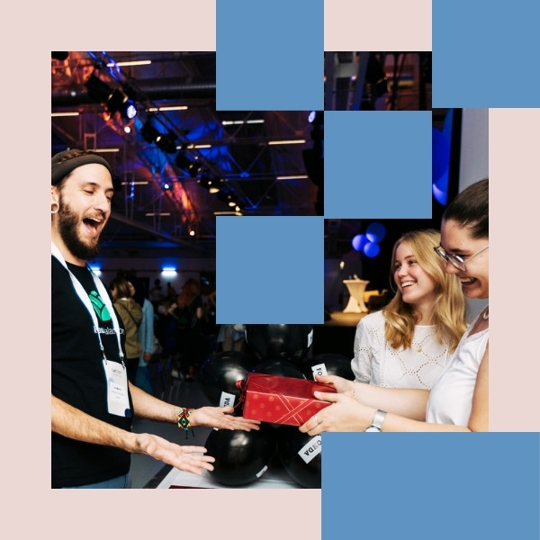A partner gives a present to one of the attendees, who is really happy about it.