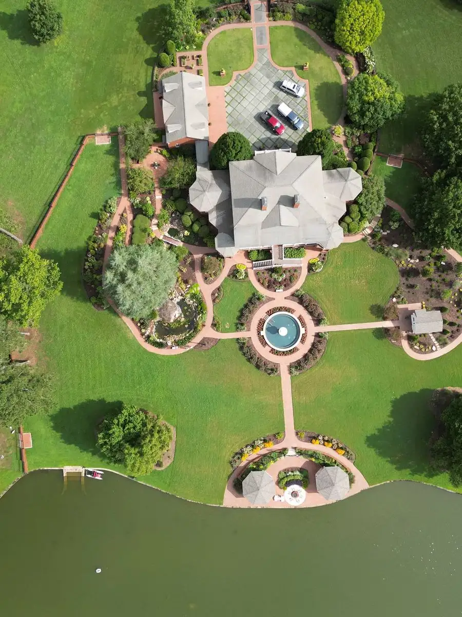 Aerial landscape design with lawn, pathway, fountain, and lake