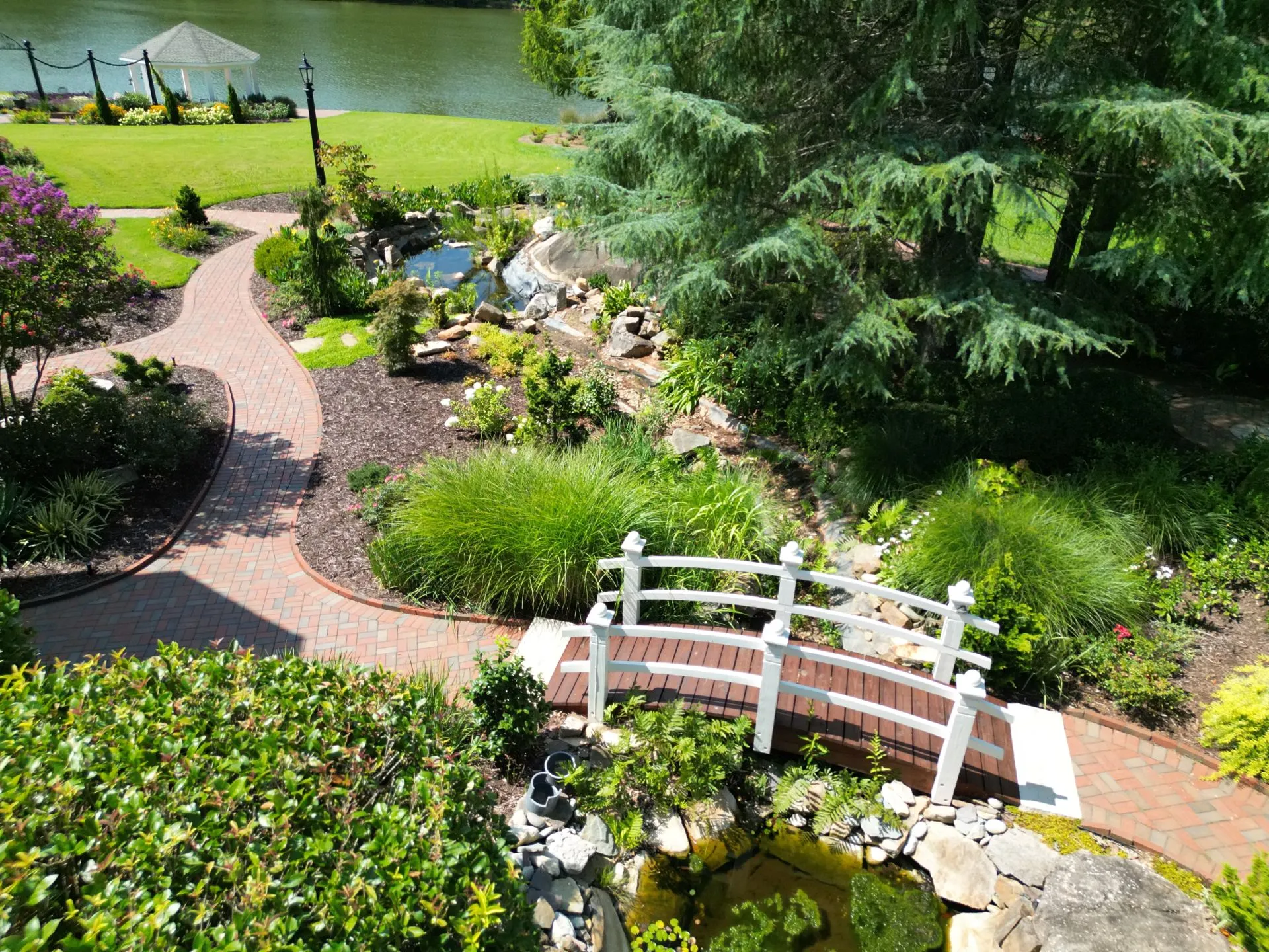 Lakefront Garden Bridge & Waterfall by Landscape Design Contractors