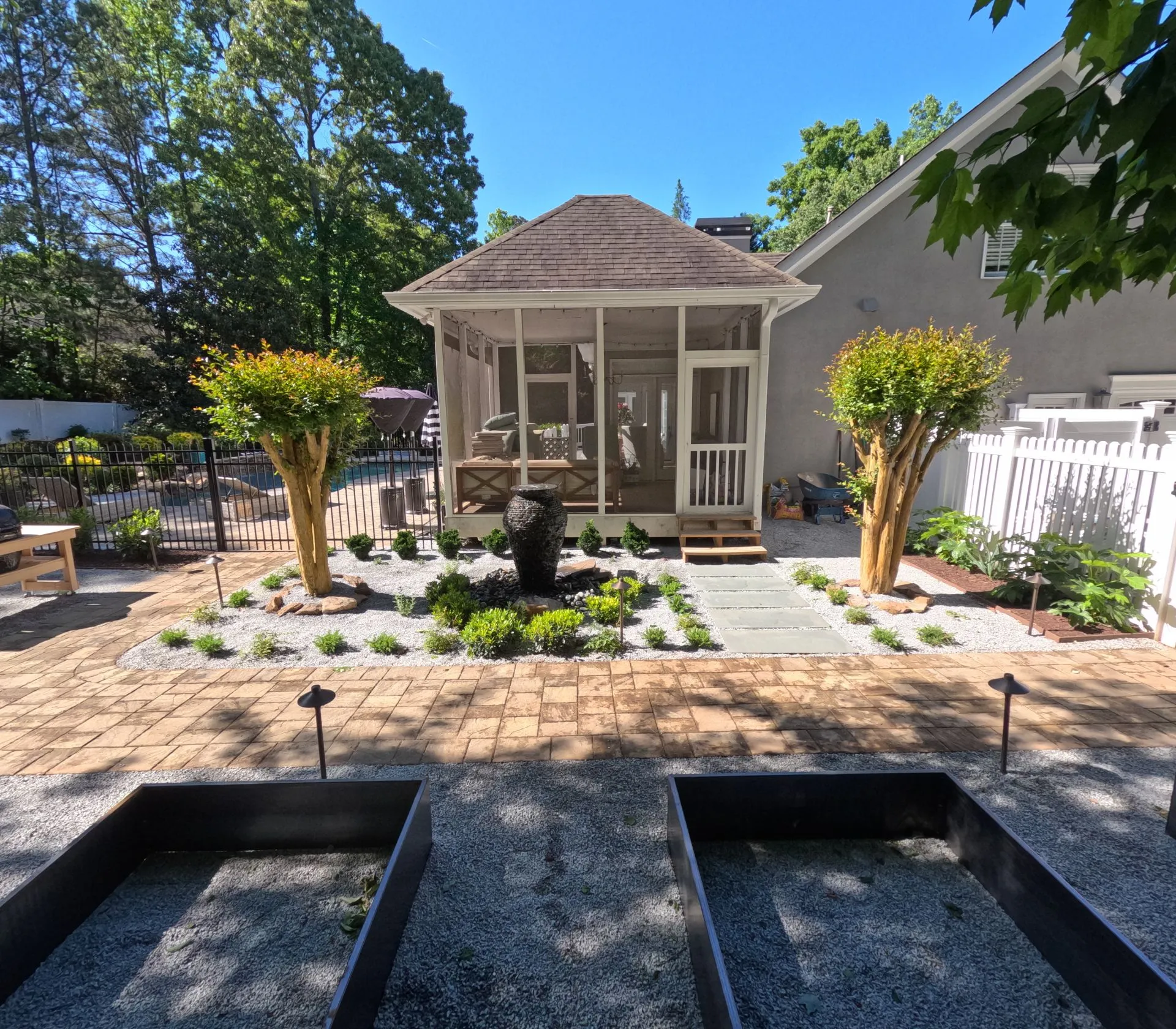Outdoor living space design with screened pavilion and garden courtyard