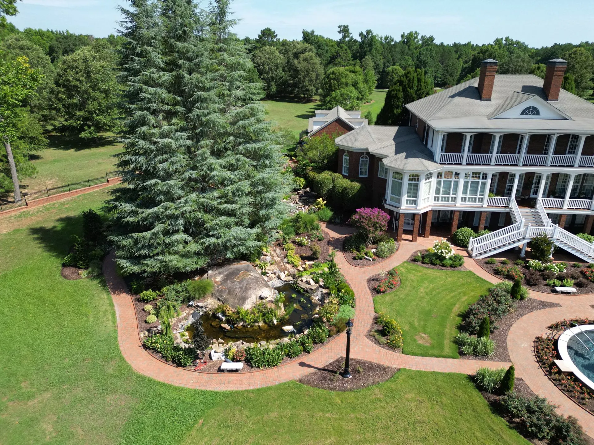 Home landscape with curved walkways and planted garden beds