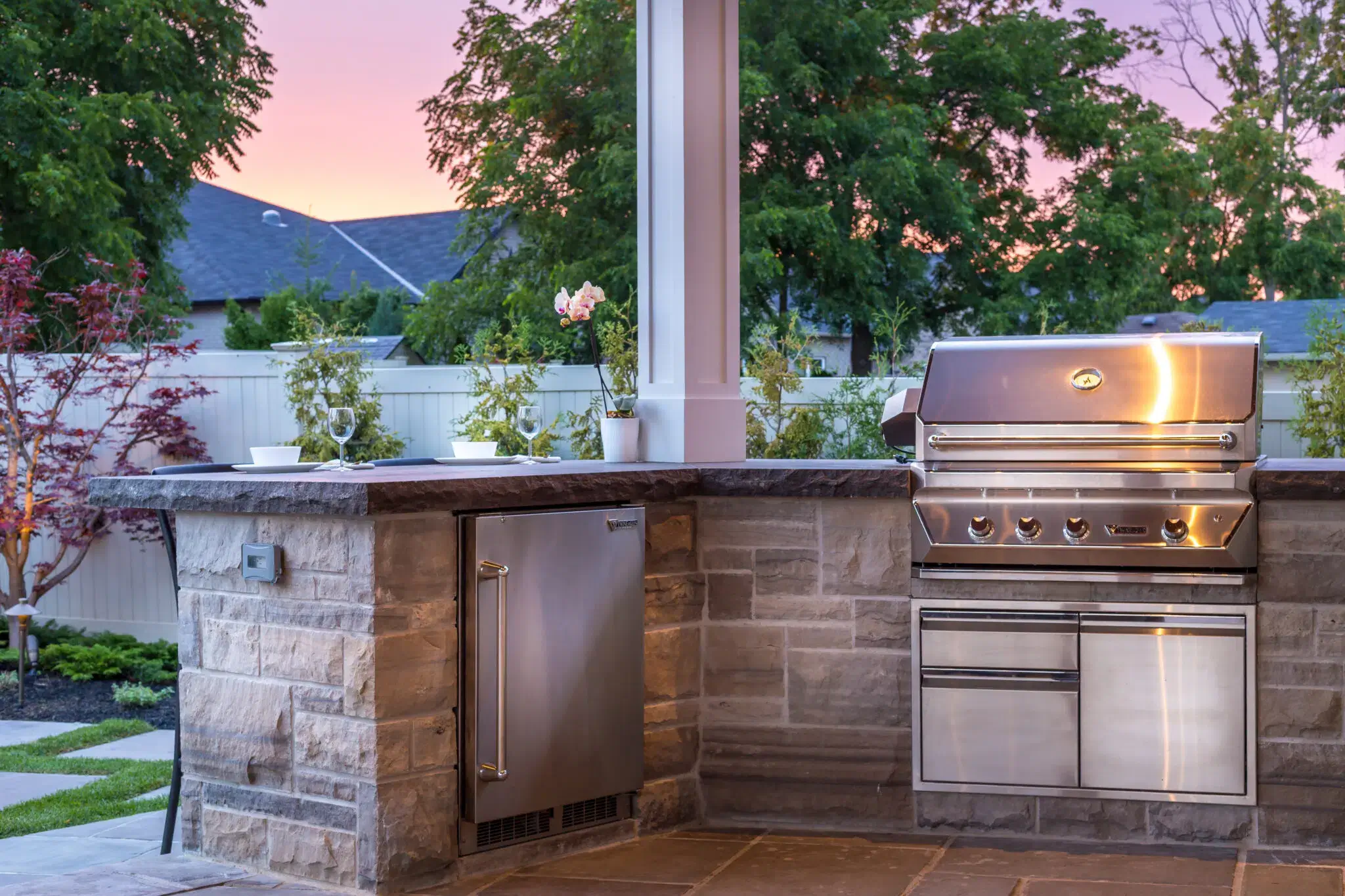 Outdoor kitchen design with built-in grill and stone countertop