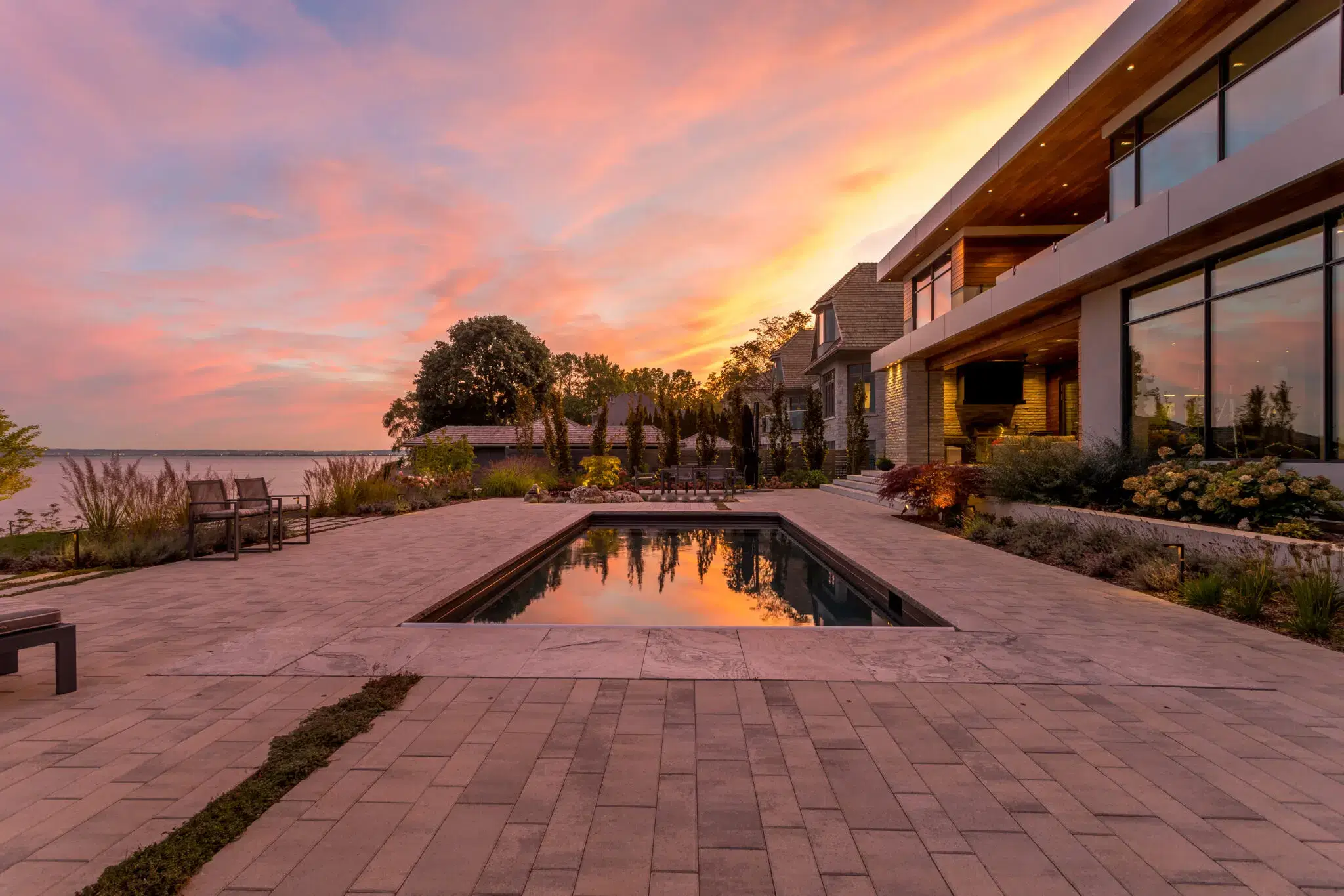 Paver Patio Around Lakeside Pool At Sunset