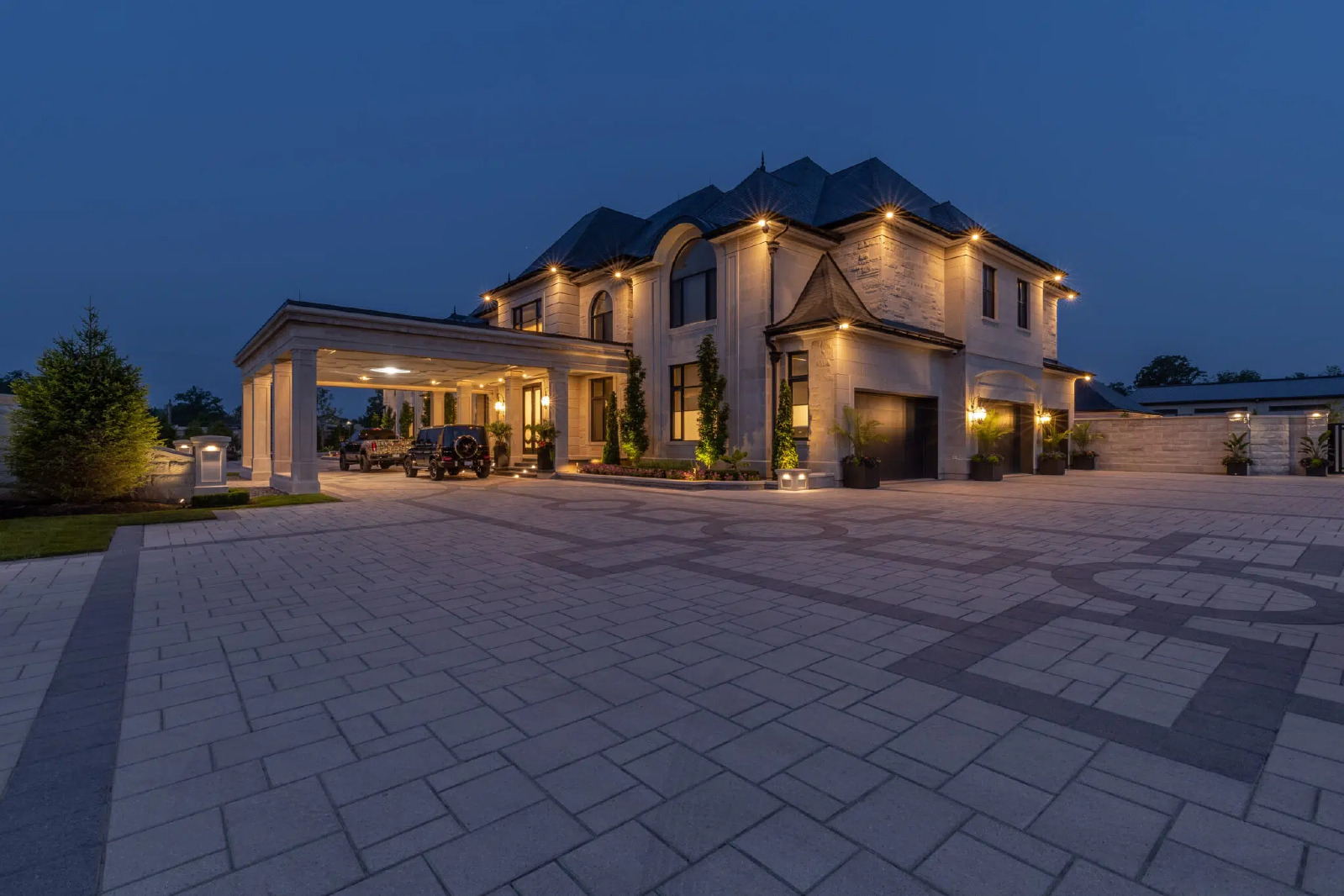 Outdoor Landscape Lighting Design Around Luxury Home And Paver Driveway