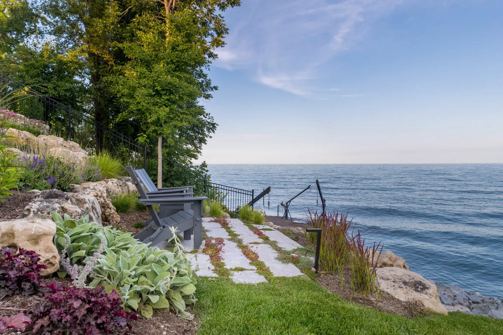 Outdoor Landscaping With Lakeside Stone Walkway And Seating