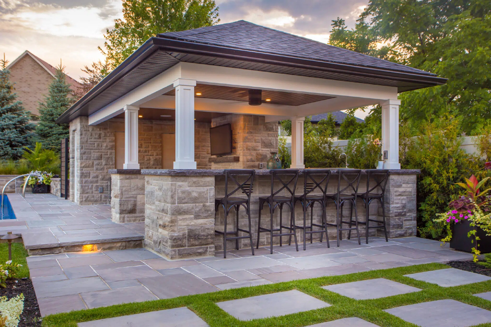 Outdoor Kitchen And Bars Beside Poolside Pavilion