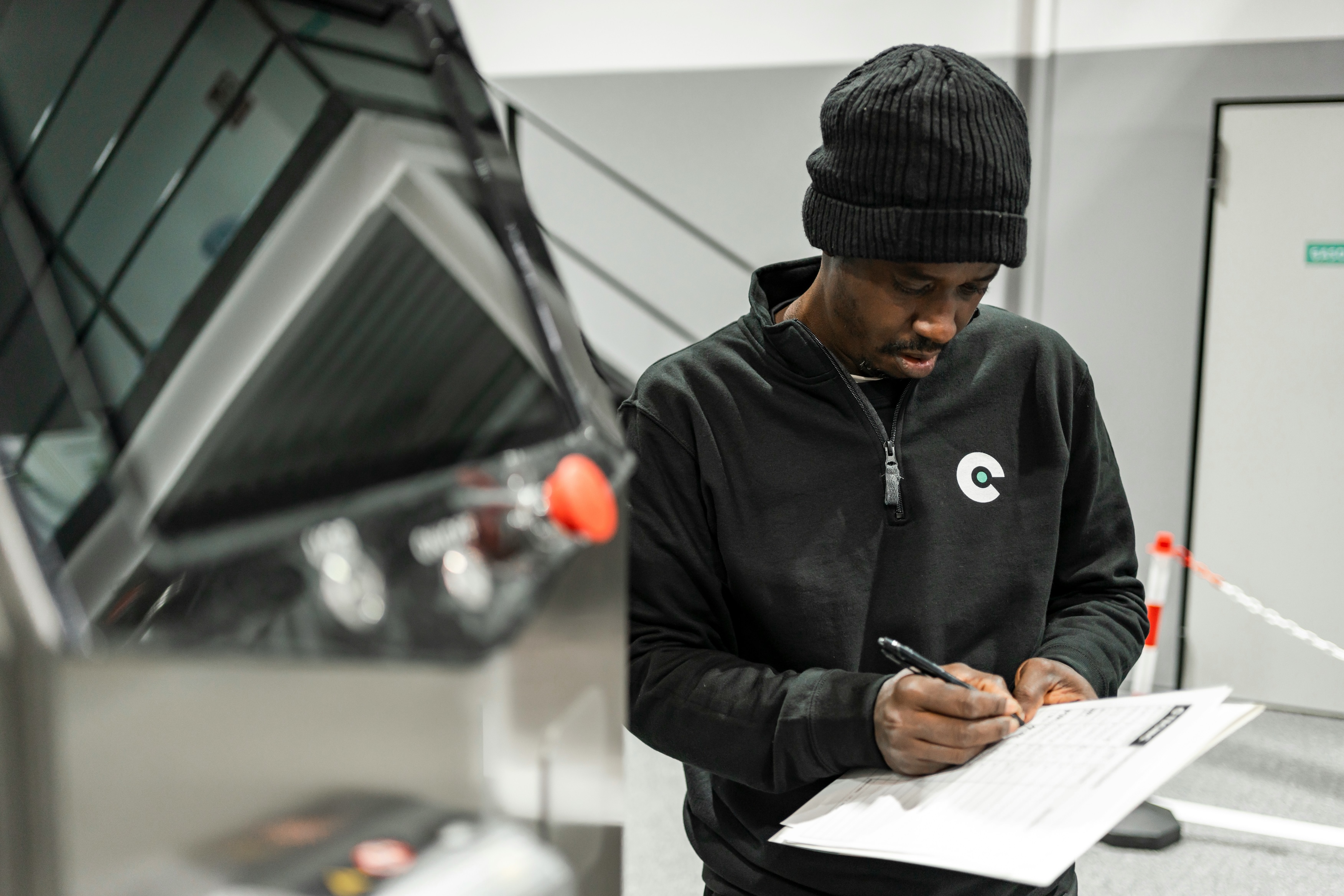 An inspector completing a checklist on site, the work accredited CBAM verifiers carry out