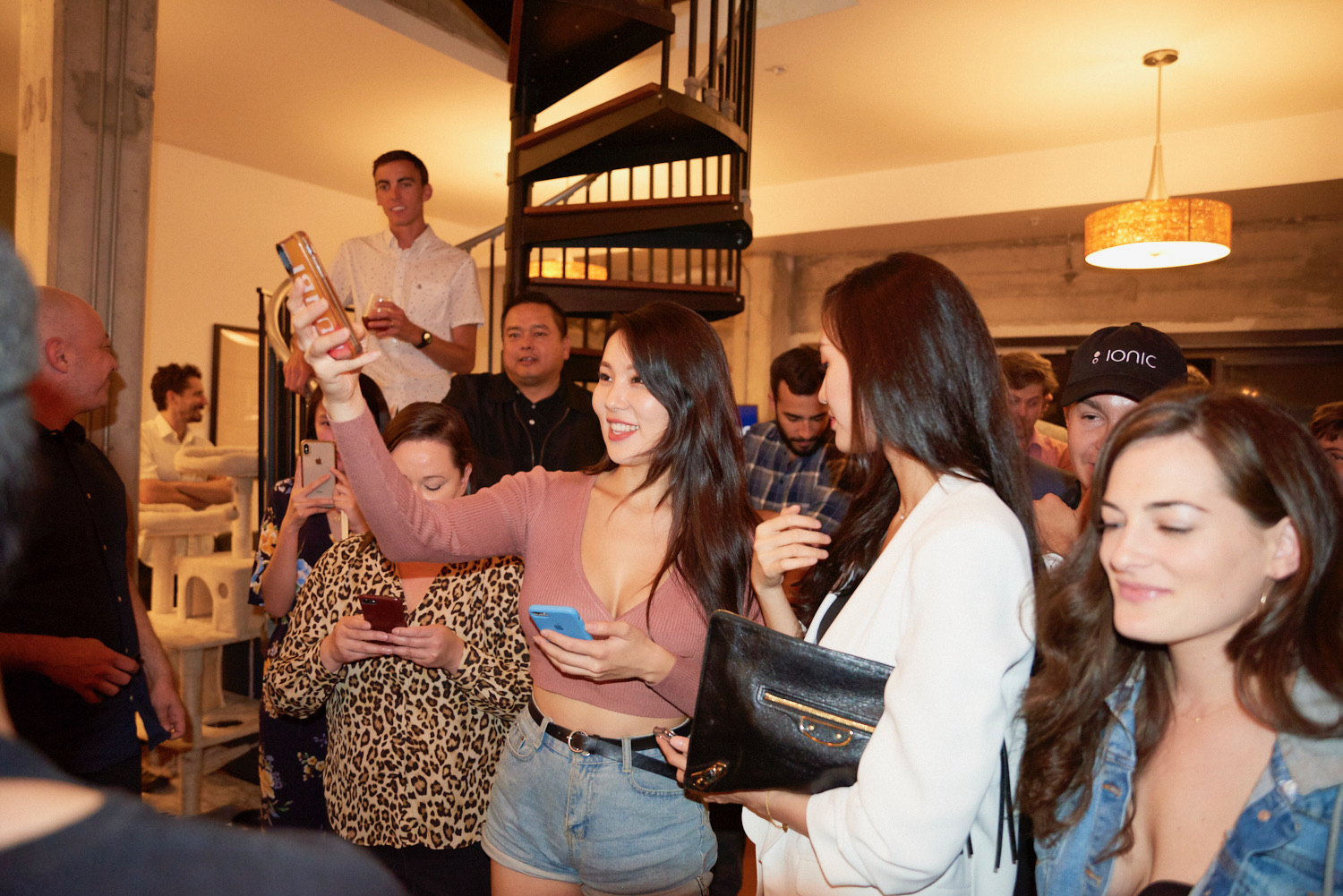 Spiral staircase to the rooftop with DTLA diners socializing