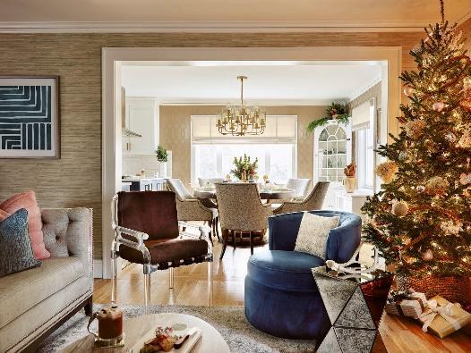An image of a living room featuring a Christmas tree with a dining room in the background.