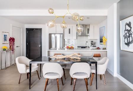 An image of Trevor Fulmer Design of modern elegance featuring dining room and kitchen in background.