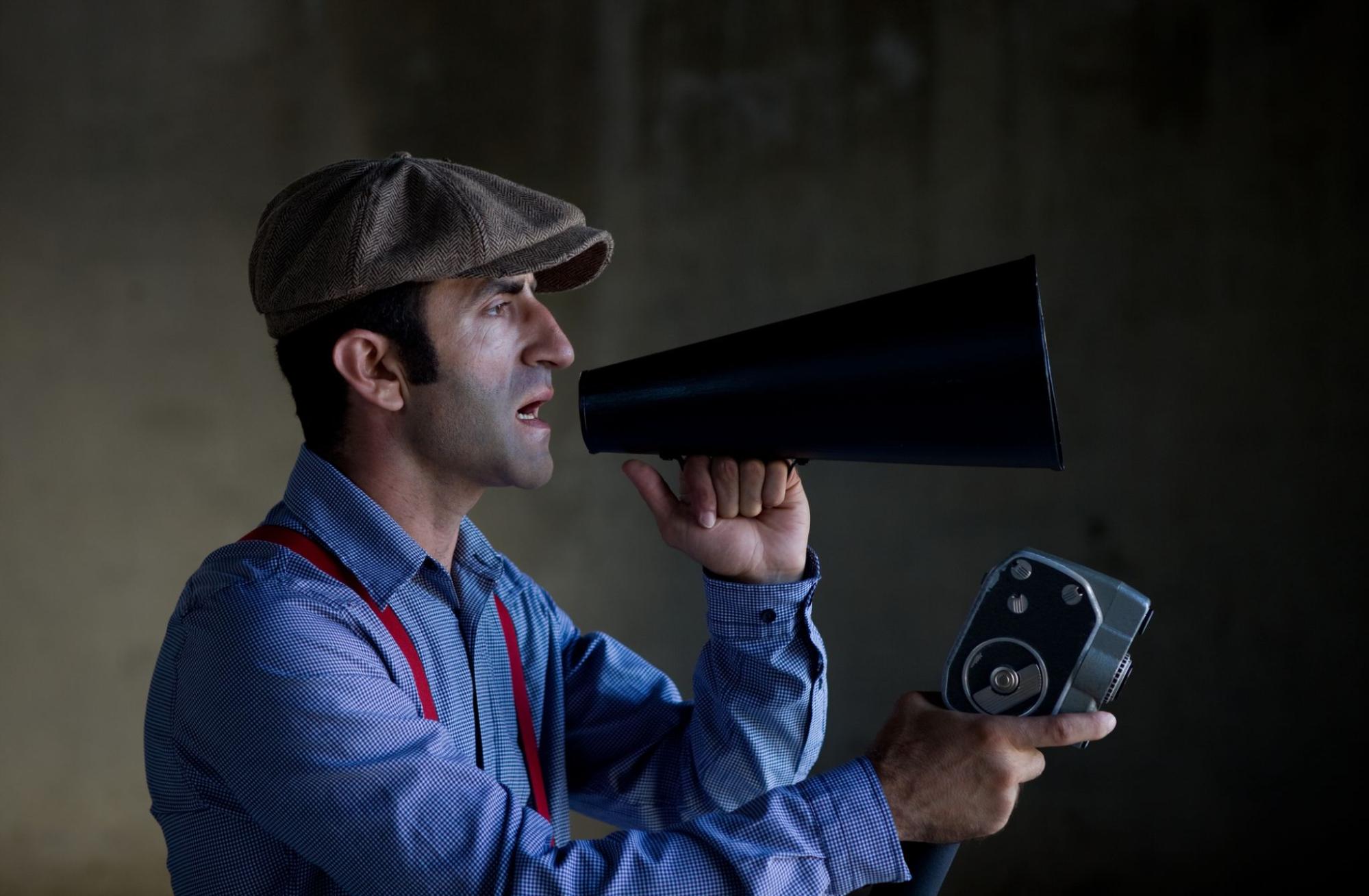 Short film director in old fashioned clothes holding video camera Short film director in old fashioned clothes holding video camera vintage movie director stock pictures, royalty-free photos & images