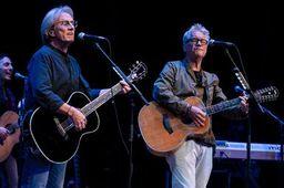 Two men playing guitars and singing