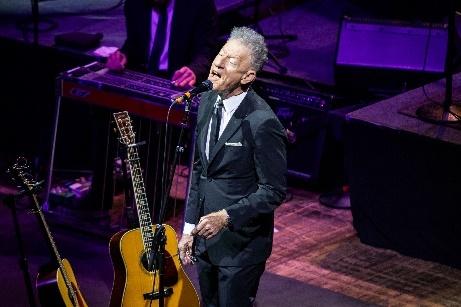 Lyle Lovett singing into a microphone