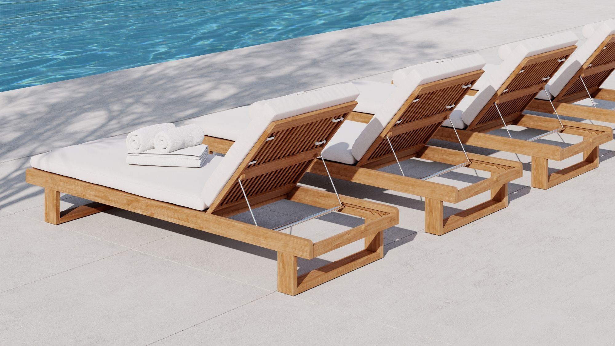 teak chaise loungers by the pool