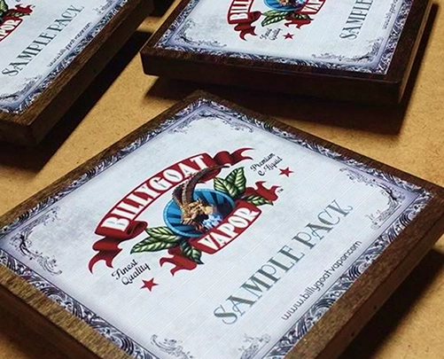 Wooden framed sample pack boxes labeled 'Billygoat Vapor' with a goat and hop cone logo on each.
