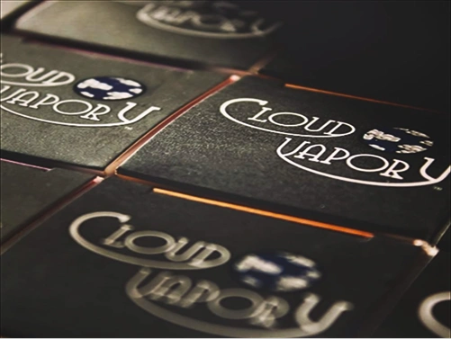 Close-up of black boxes with the Cloud Vapor logo and blue cloud icon on them.