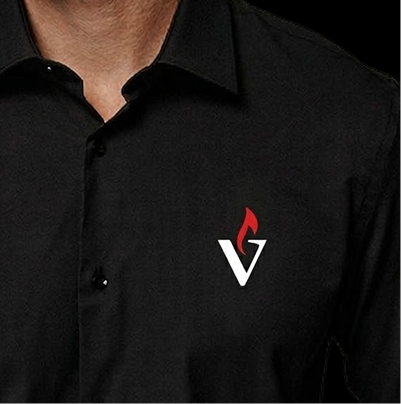 Person wearing a black shirt with a white 'V' logo topped with a red flame on the chest.