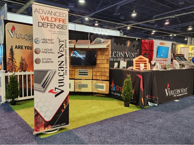 Trade show booth for Vulcan Vent showcasing advanced wildfire defense products with displays and informational banners.