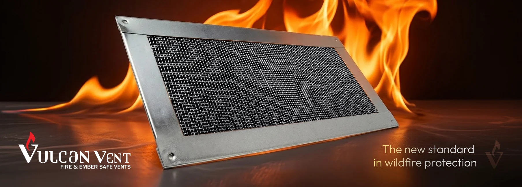 Metal wildfire vent with mesh screen in front of flames, labeled Vulcan Vent fire and ember safe vents.