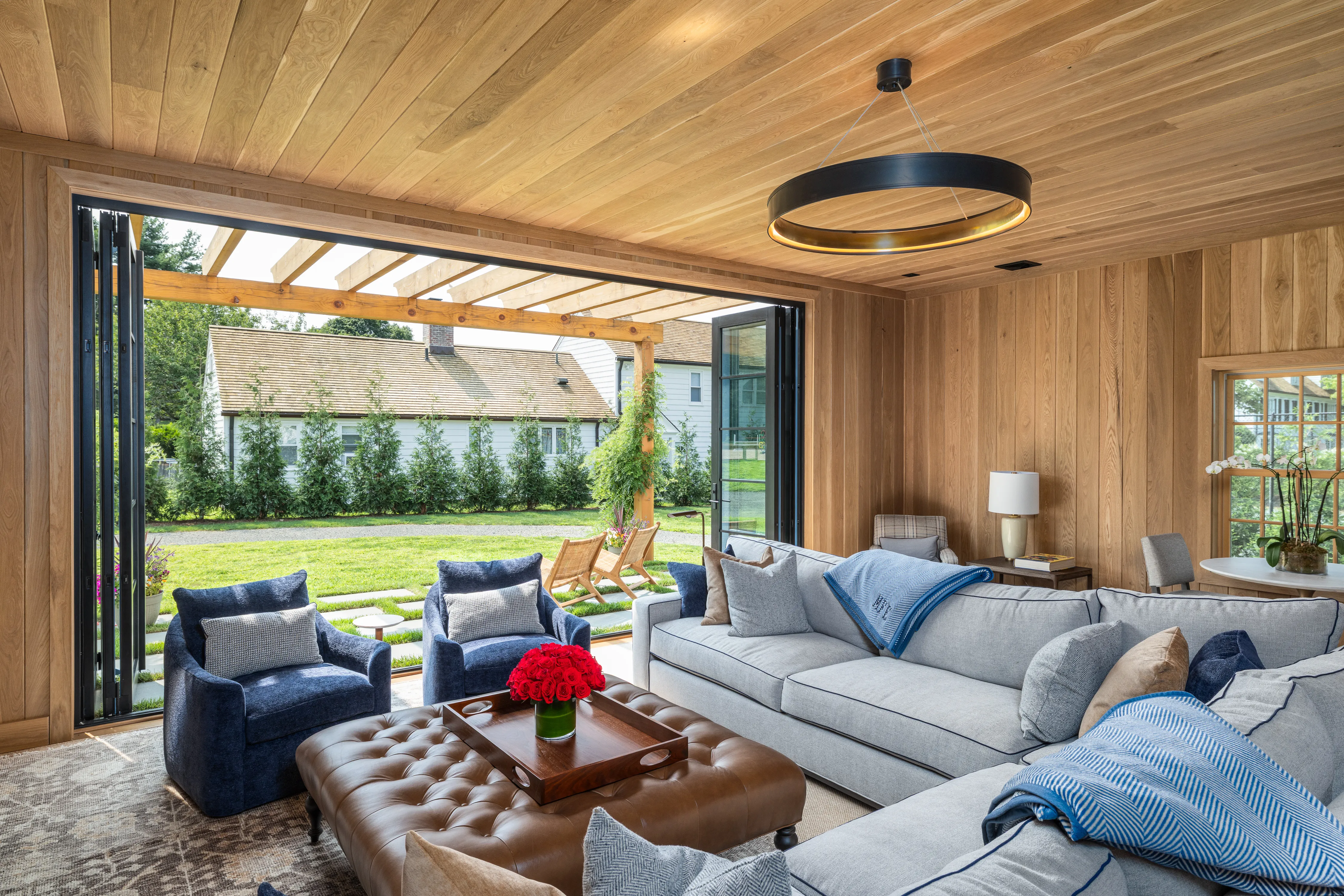 The owner’s suite in the horse barn blends seamlessly with the outside, with large bi-folding doors opening to a pergola-covered patio.