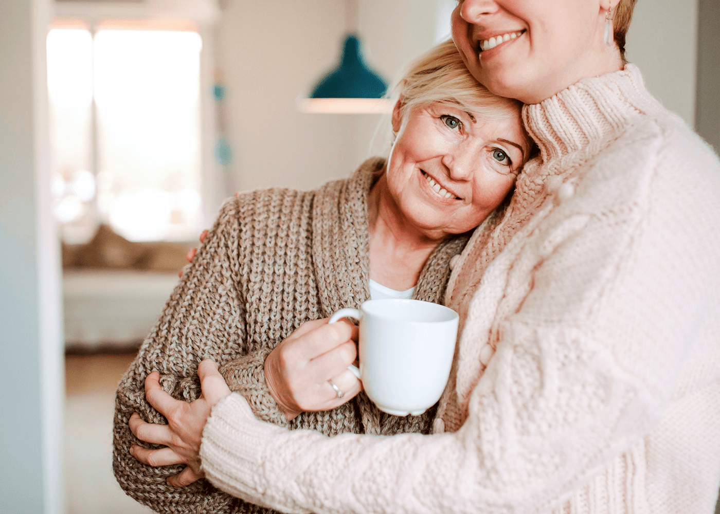 Two friends laughing over tea