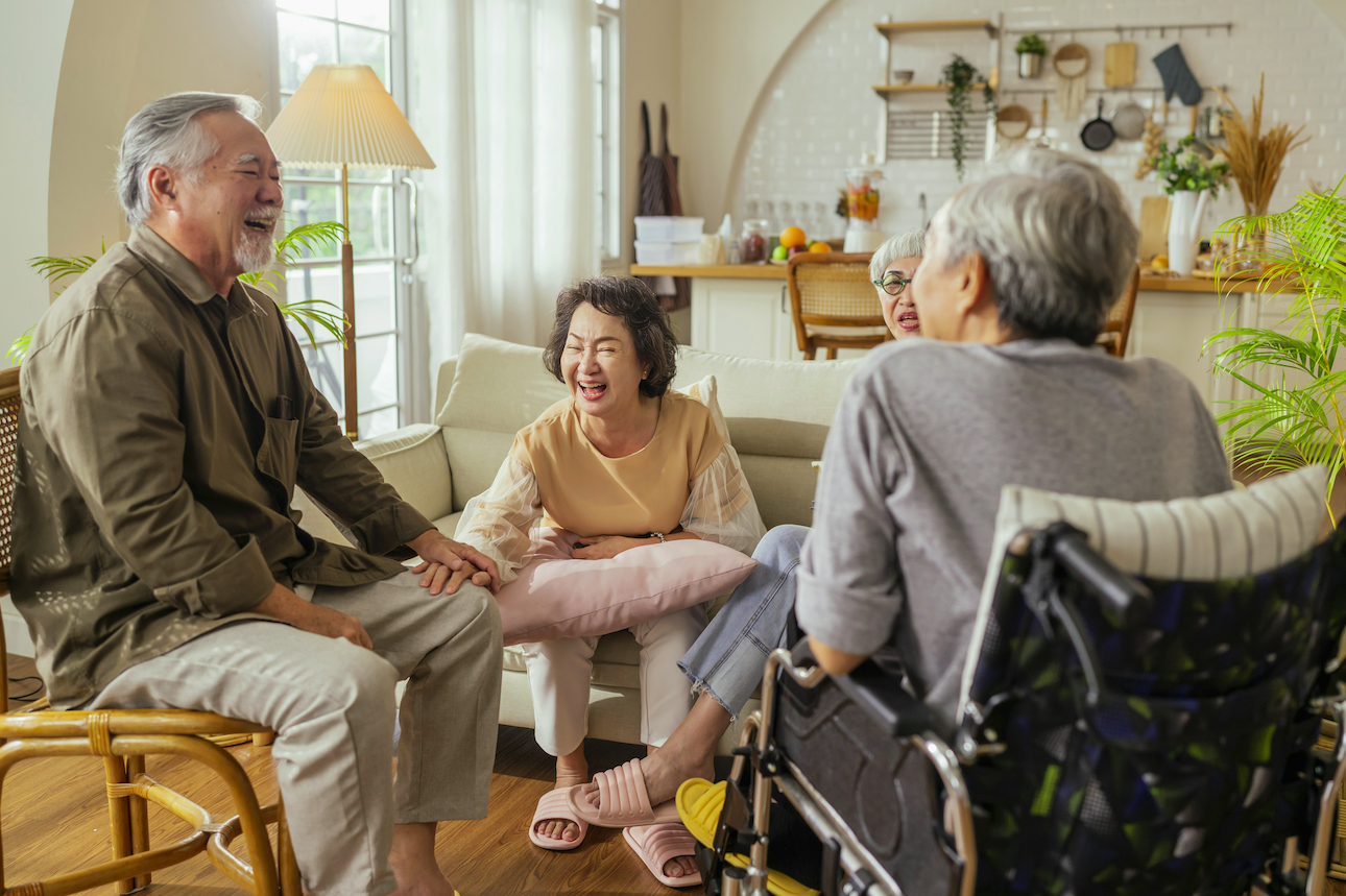 Friends and family laughing together in a cozy living room