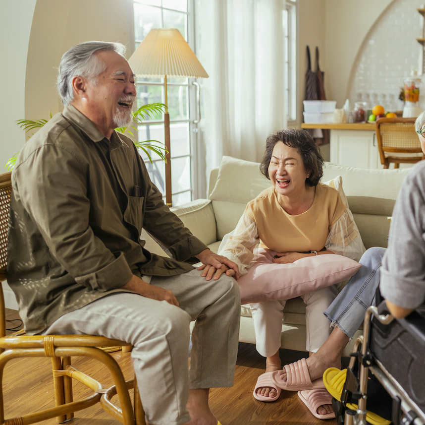 Friends laughing together at a get-together in the living room