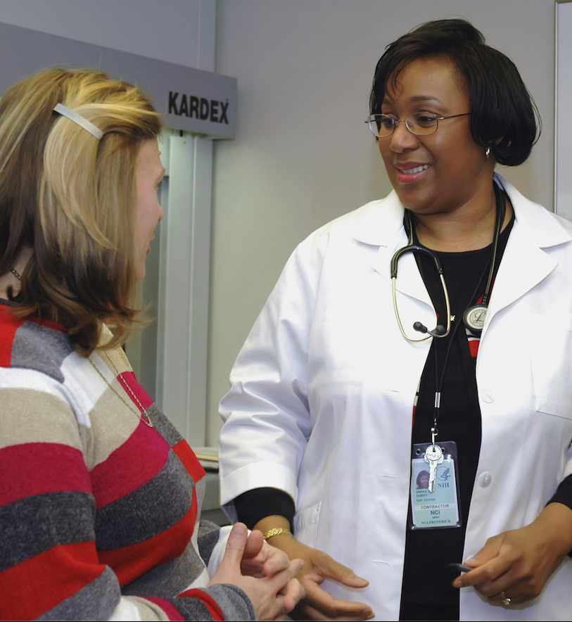 A woman talking with her smiling doctor during an appointment