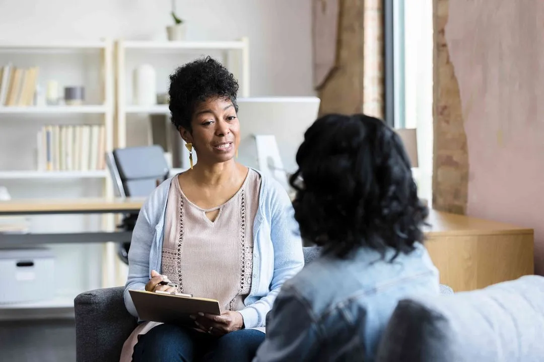 Patient talking with a dentist in the clinic lounge