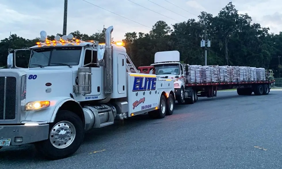 Elite Towing and Recovery heavy duty tow truck towing a semi truck in Gainesville, FL