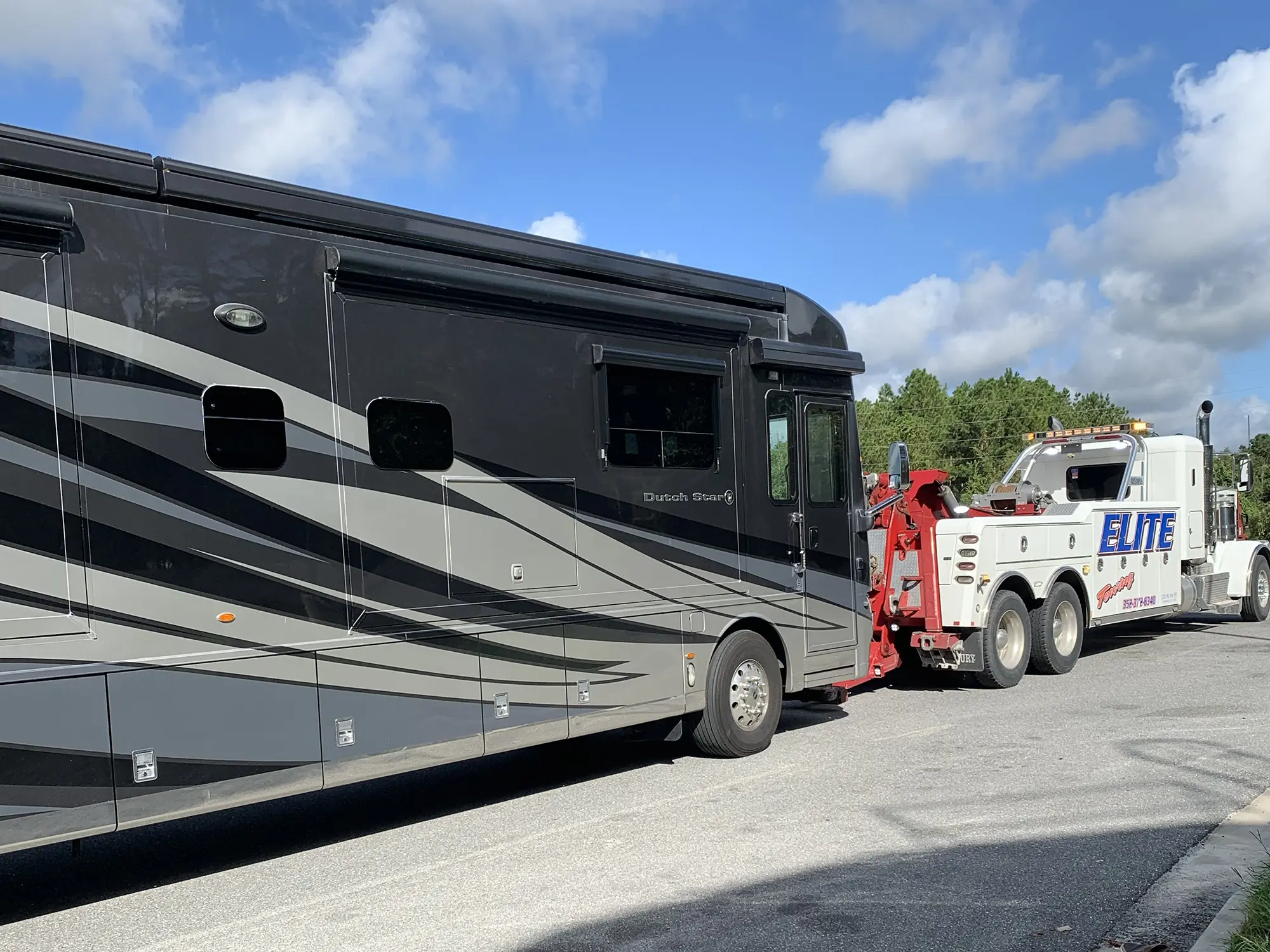 Elite Towing and Recovery heavy duty wrecker towing an RV in Gainesville, FL