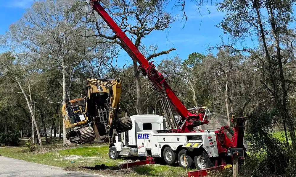 Elite Towing and Recovery rotator tow truck lifting an overturned vehicle in Gainesville, FL