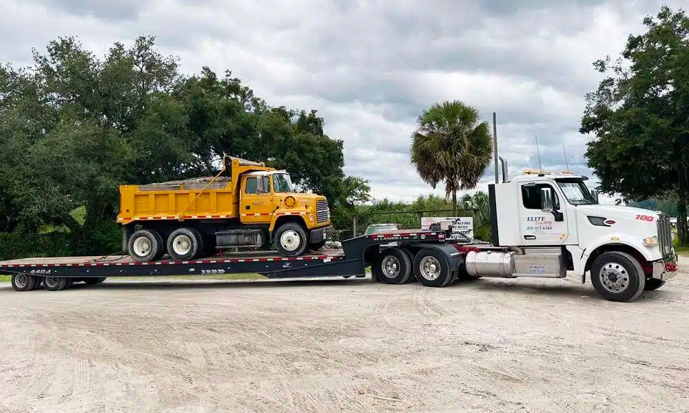 Elite Towing and Recovery Landoll trailer loading a low-clearance vehicle in Gainesville, FL