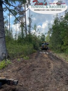 Heavy Duty Towing Service Rescuing A Loader Stuck In Muddy Ground