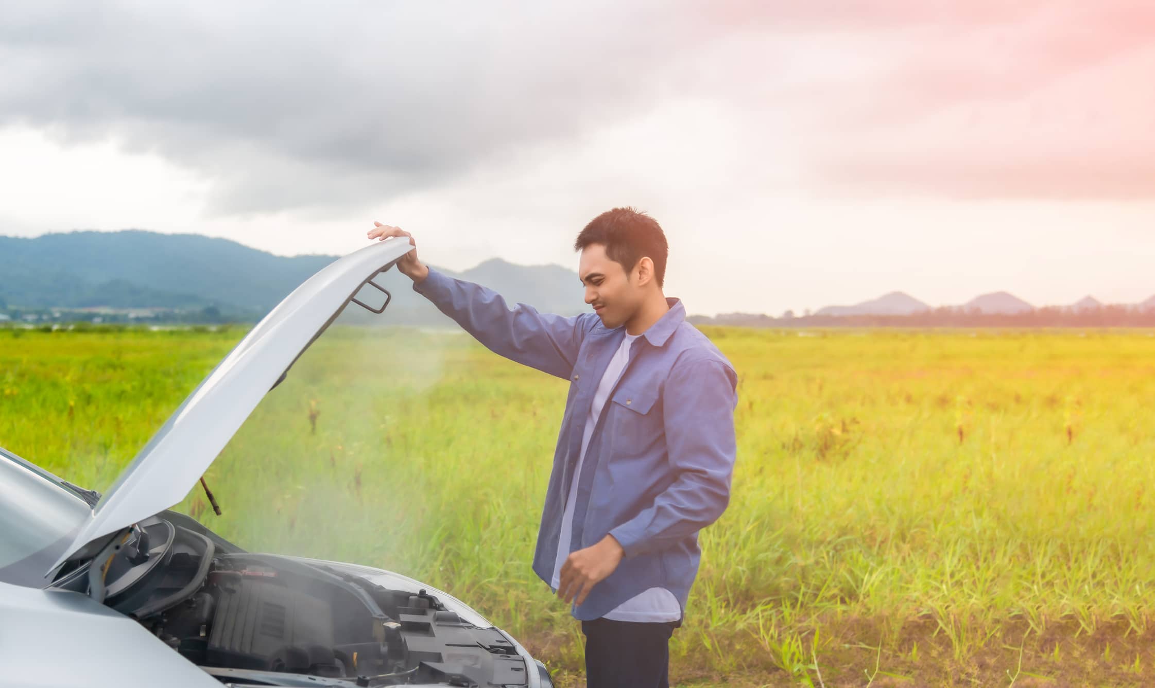 Overheated Car Receiving Roadside Assistance From A Towing Service
