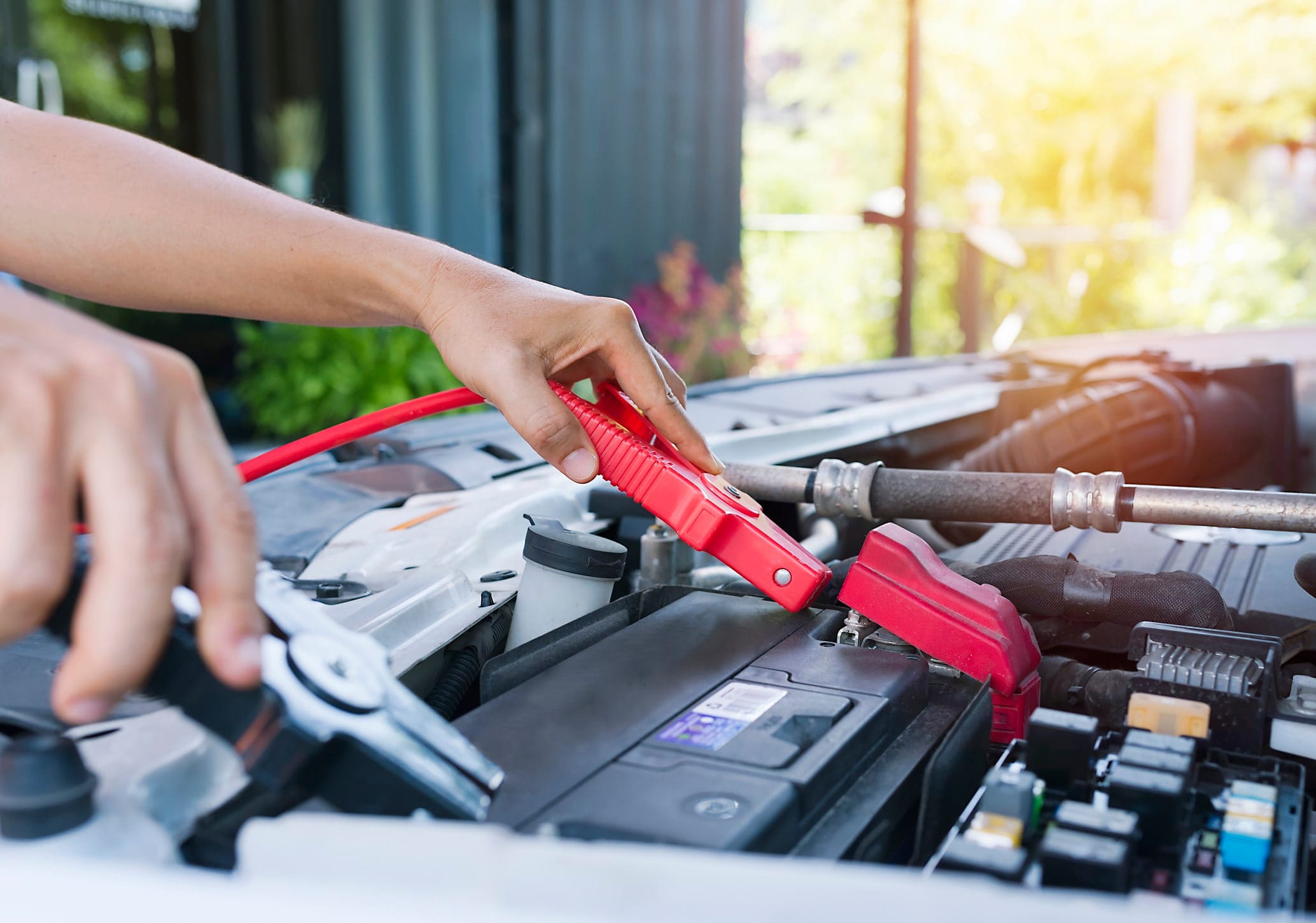 Roadside Assistance Using Jumper Cables To Start A Dead Car Battery