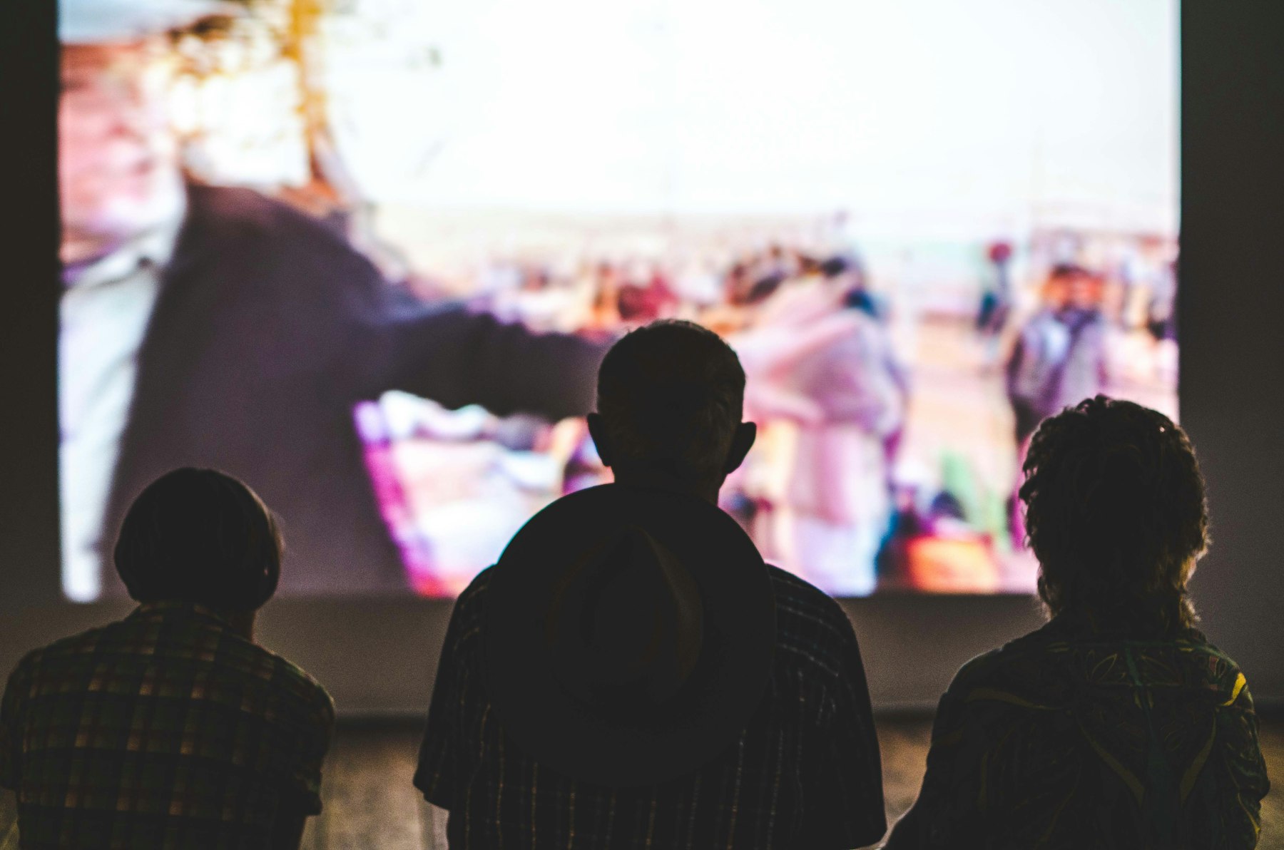 Audience silhouetted in front of a large screen