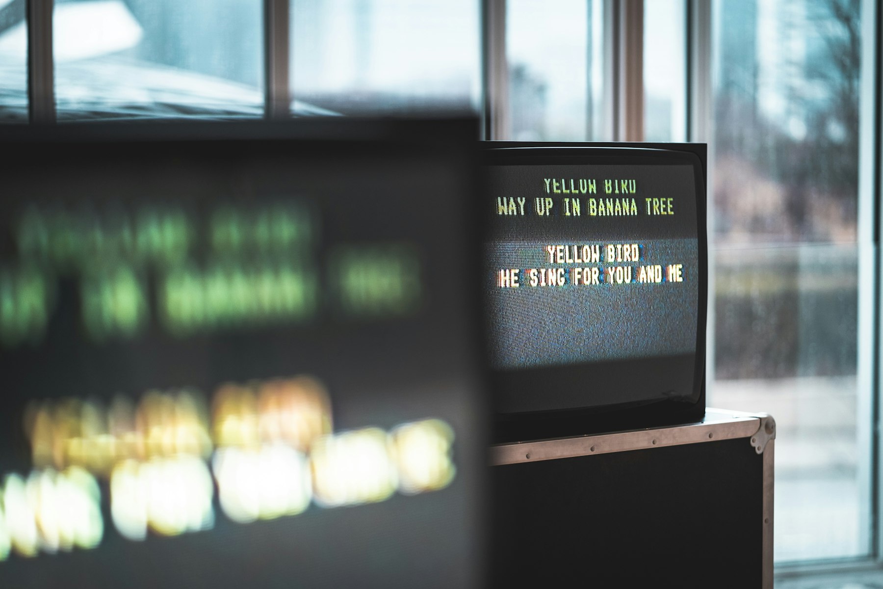 Broadcast monitor displaying yellow caption text