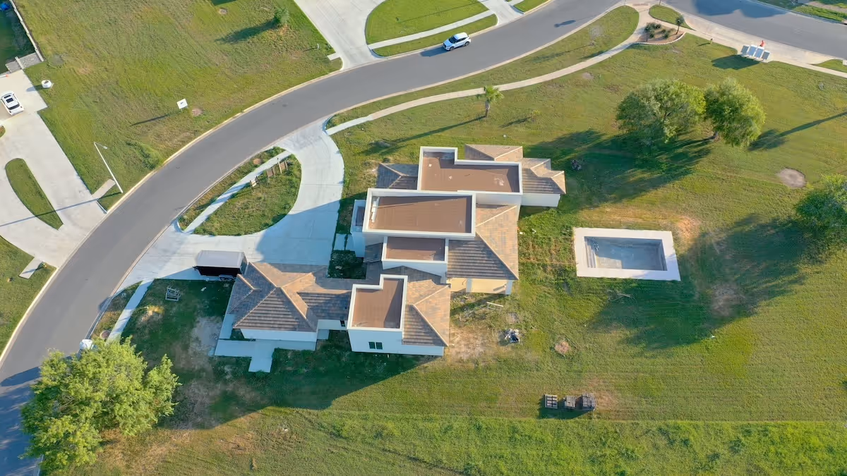 Aerial drone view of completed custom home roof by Arrow Roofing in South Texas