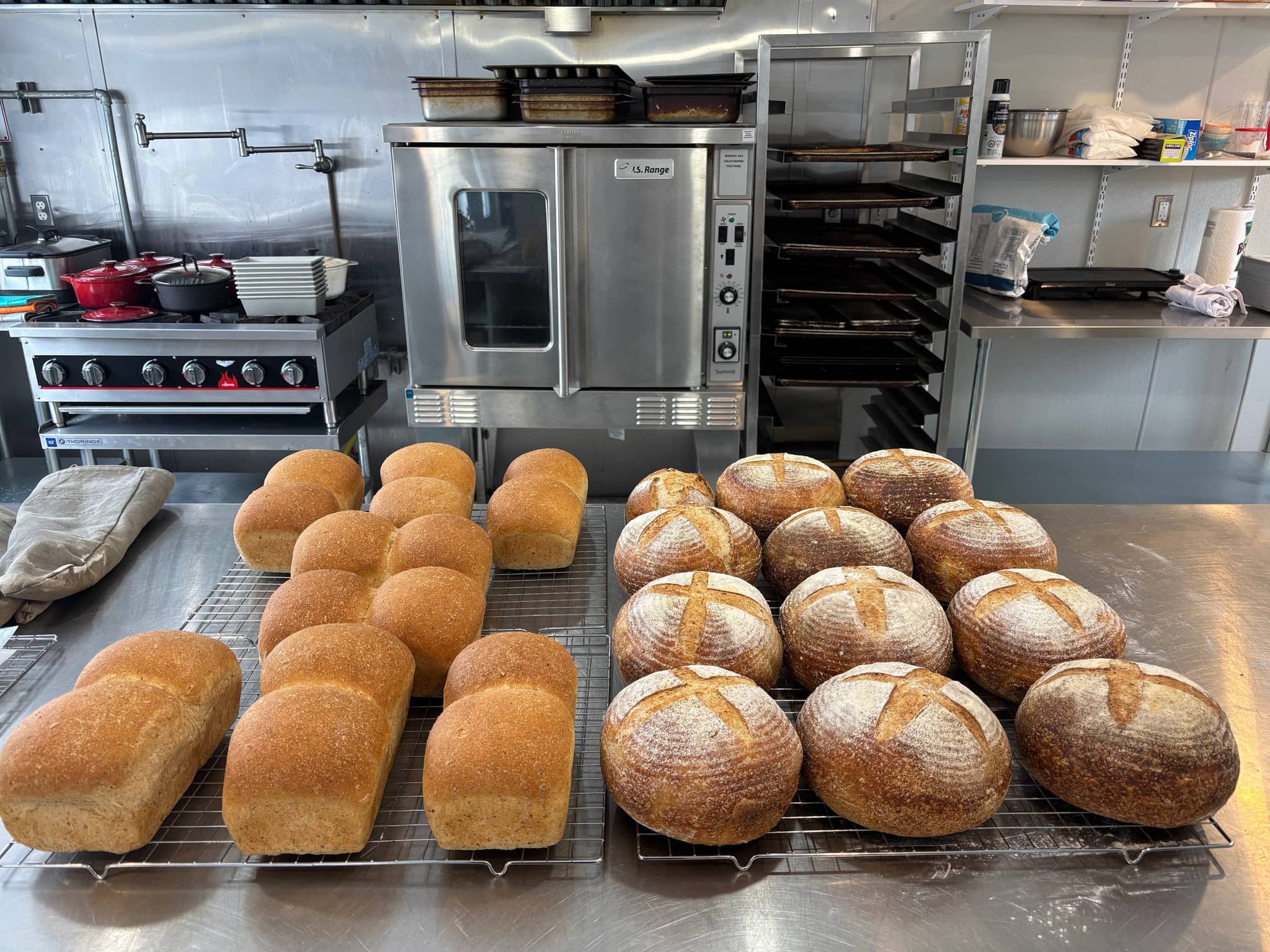 Two different kinds of sourdough bread on baking trays.