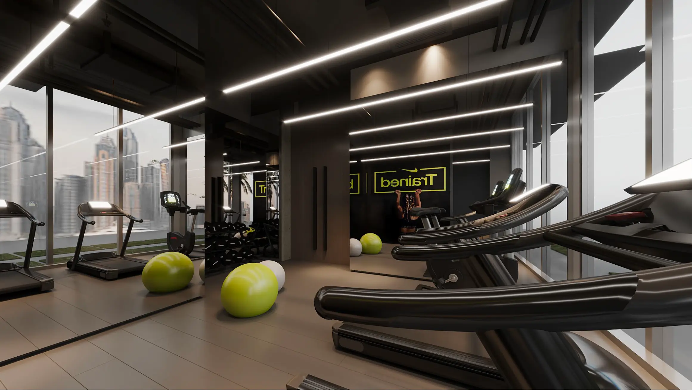 Modern gym interior with treadmills, exercise balls, and a person using a wall-mounted pull-up bar.