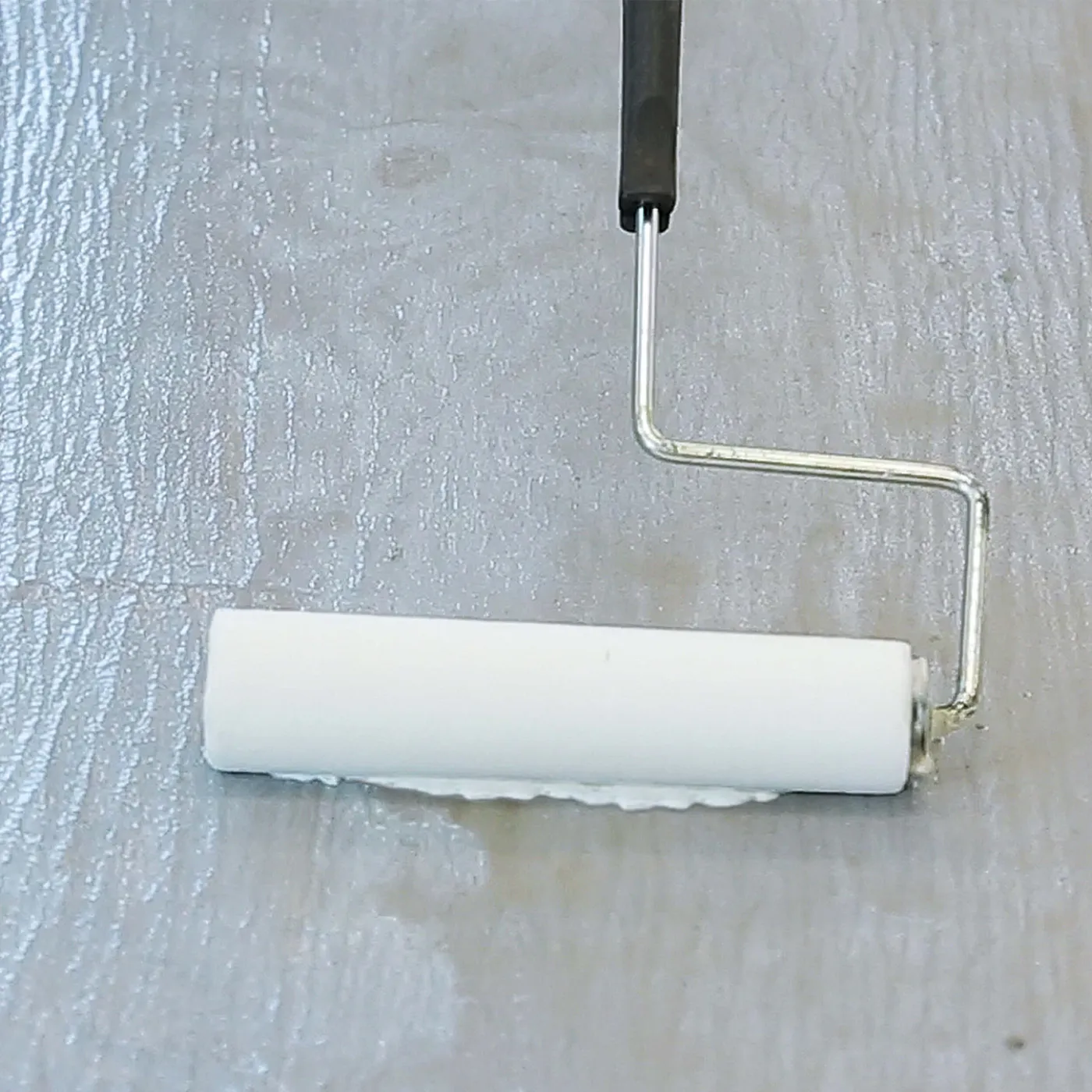 Laticrete Primer Plus being rolled onto a concrete floor