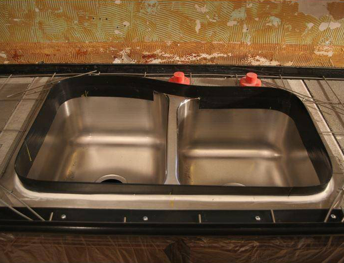 Faucet Knockout plugs installed in a sink mold before a concrete pour