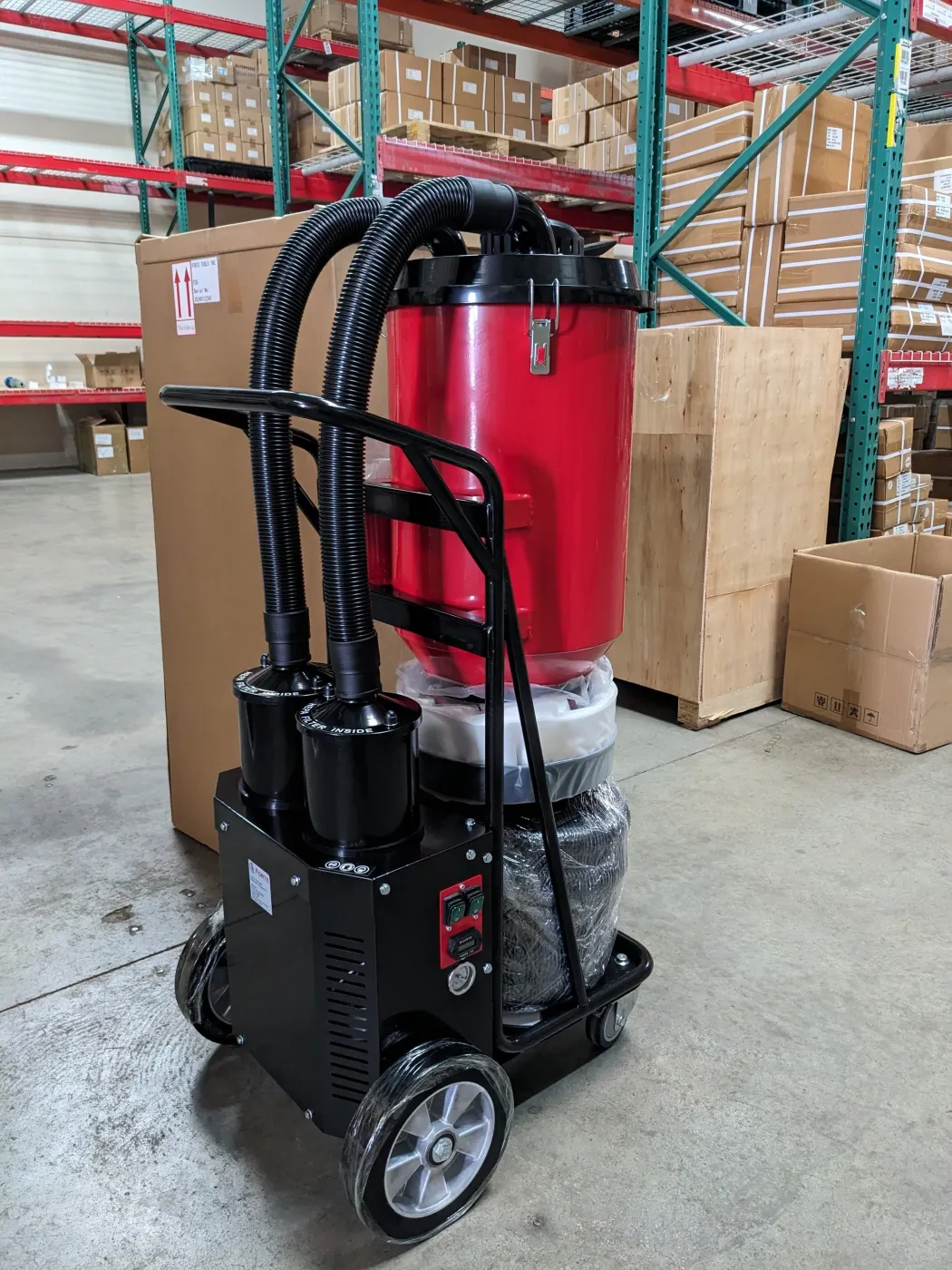 Forte F26 dust extractor in a warehouse, side view with hose