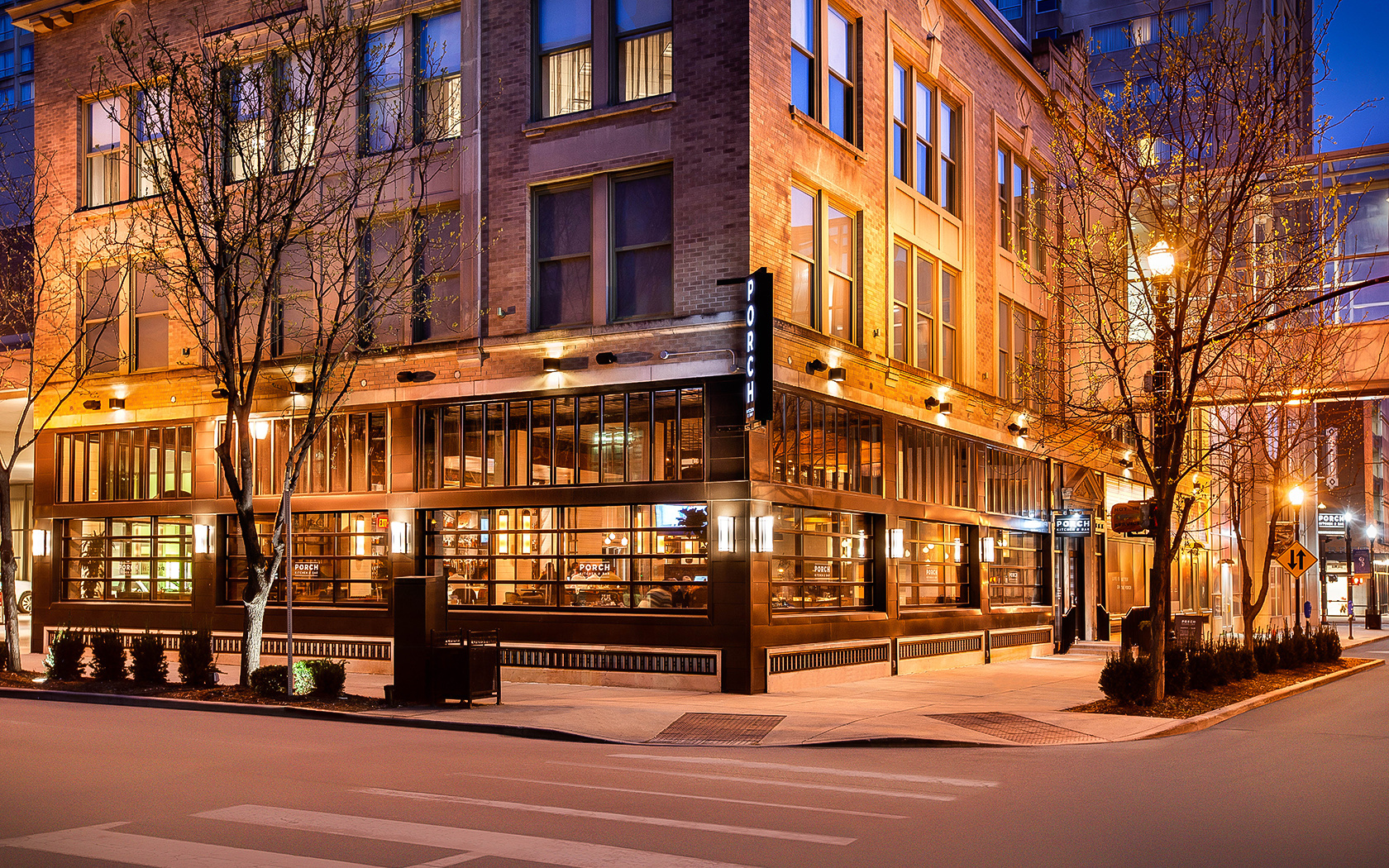 Porch Kitchen and Bar at the Louisville Marriott Downtown, lit up at dusk