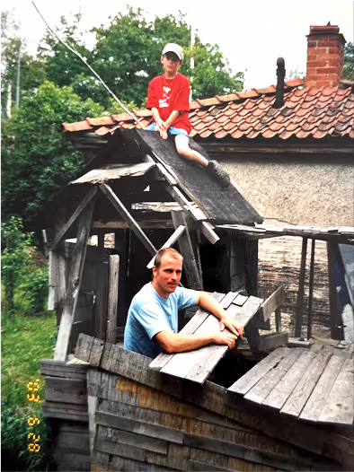 Young Anton Womann with his father working in the yard.