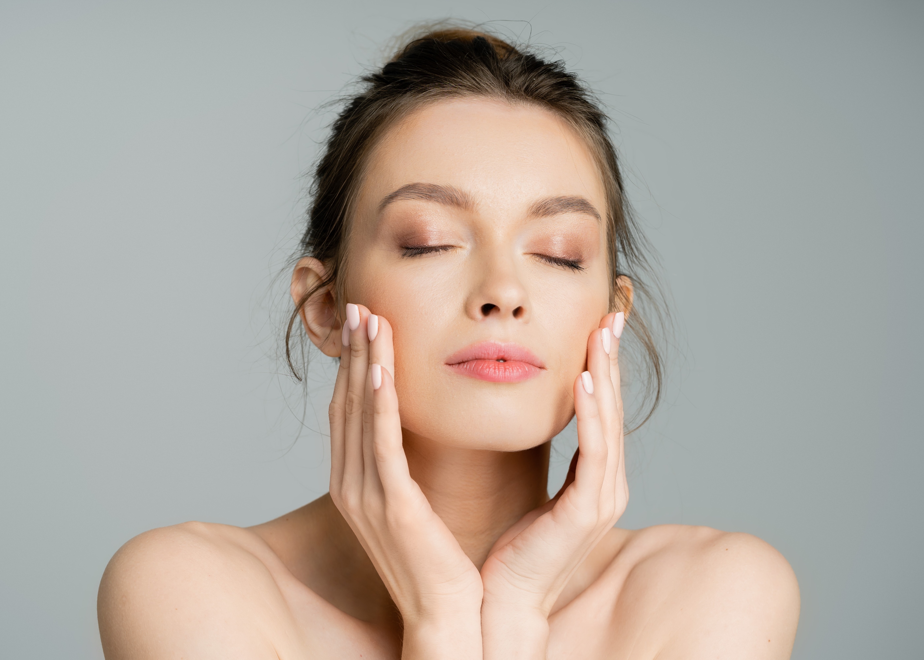 woman touching cheeks