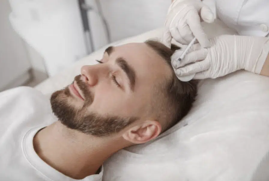 man receiving hair loss treatment
