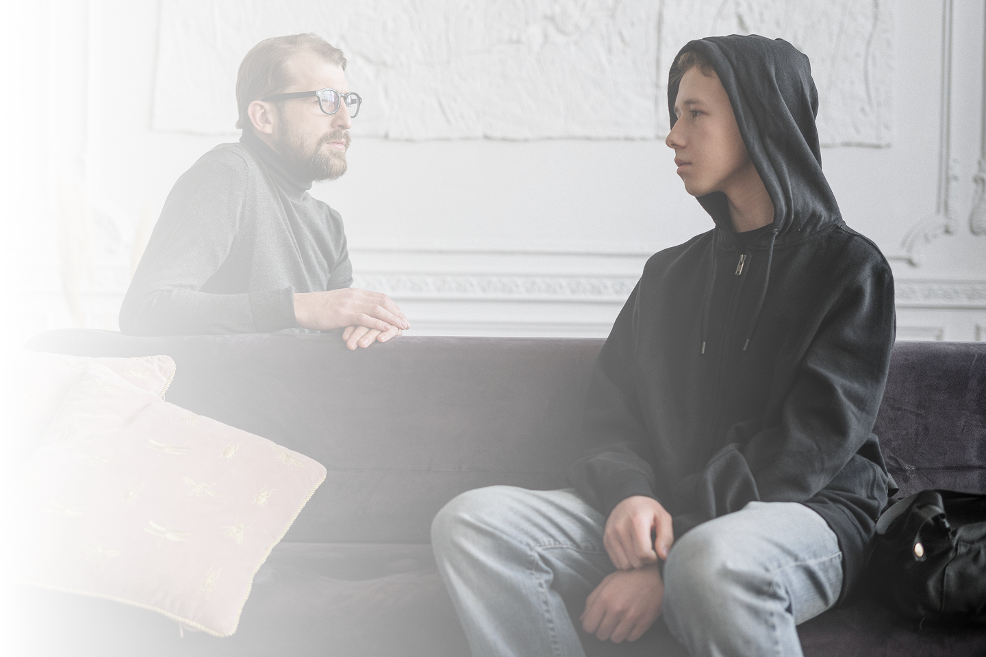 A young person and caregiver speaking with an Idaho Youth Ranch counselor.